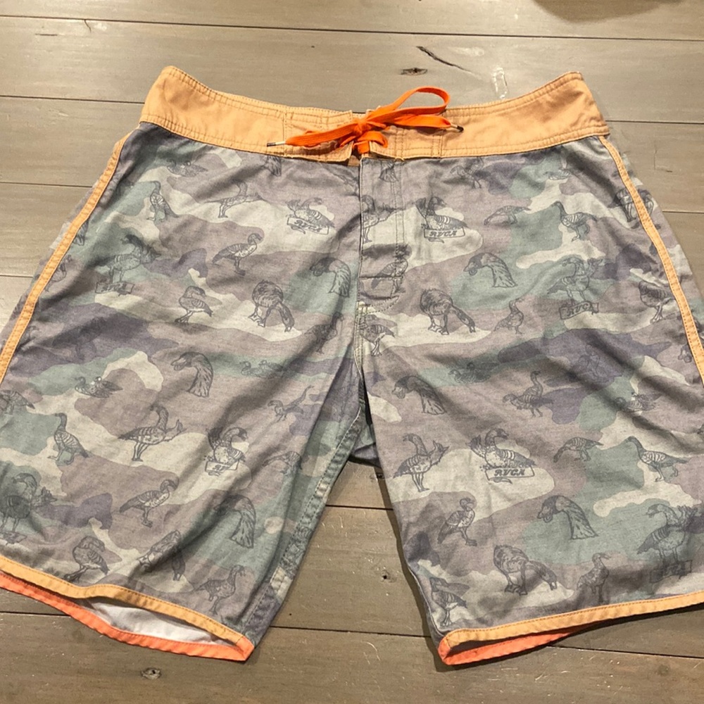 Camo RVCA shorts with duck print on them